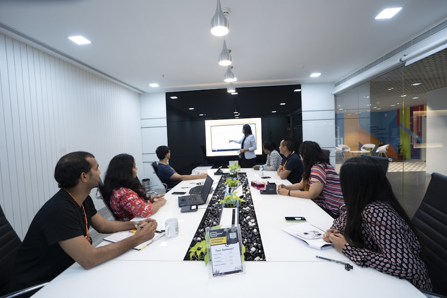 A small team listening to a colleague in a meeting room